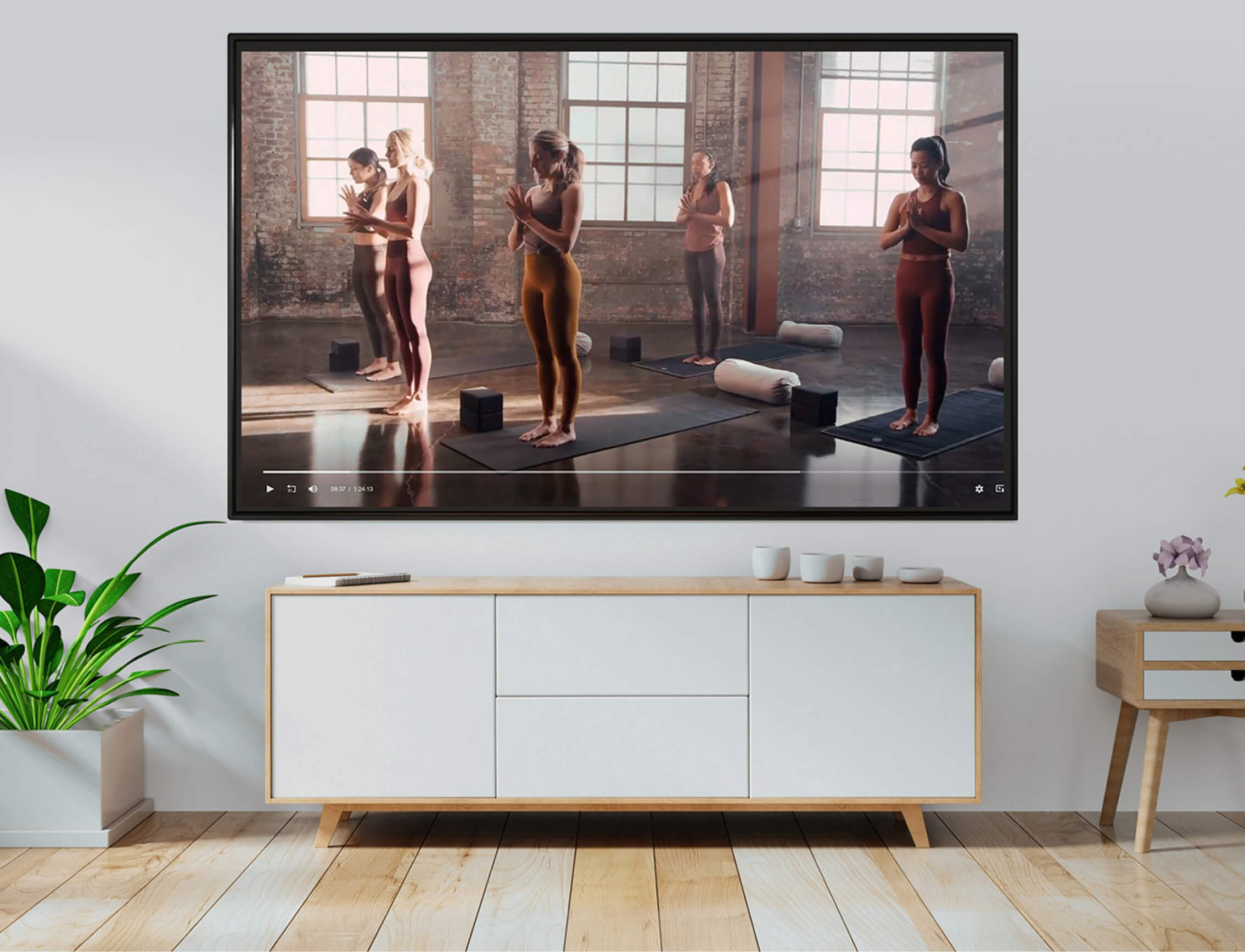 room with tv on the wall where playing yoga course