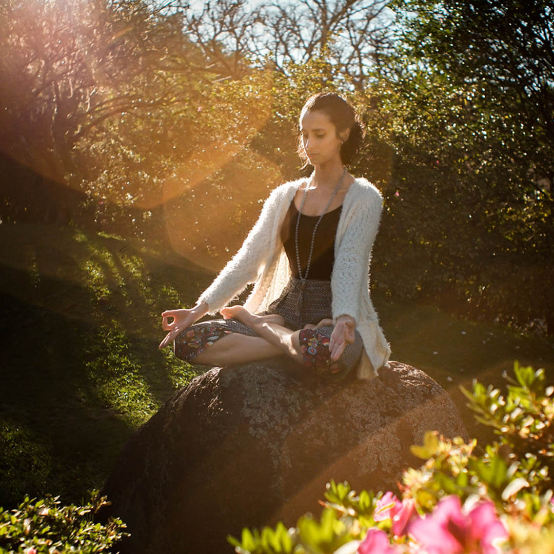 woman meditating on rock four types of meditation